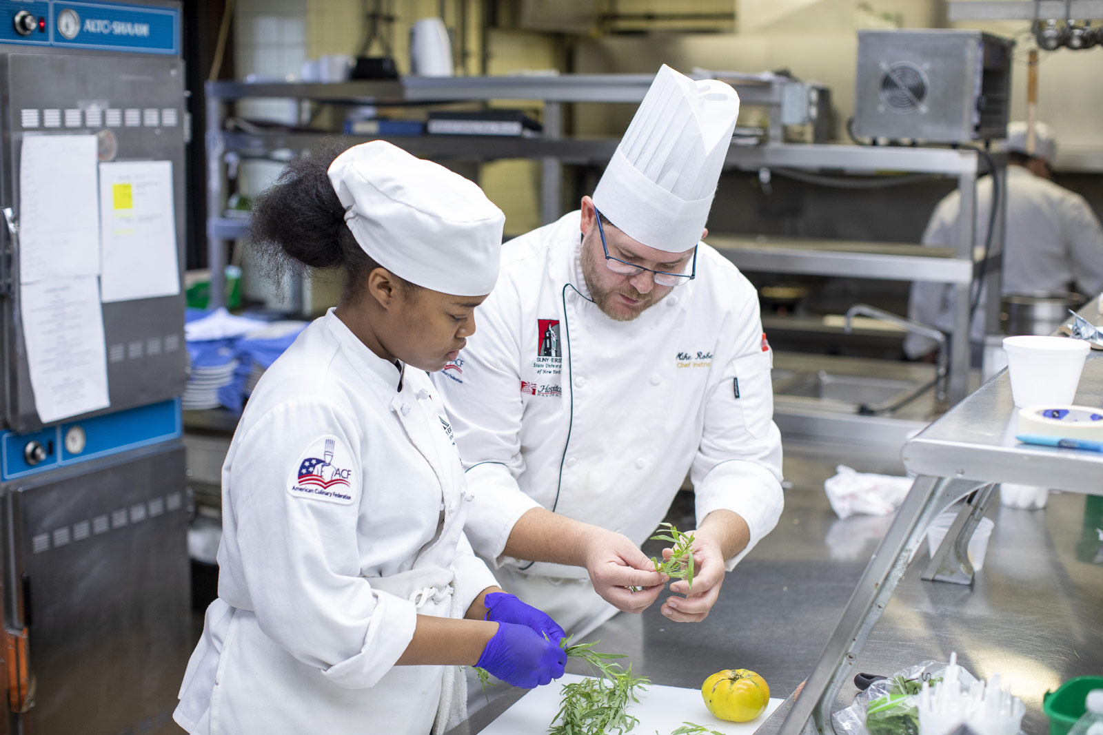 Student chef and teacher learning in the kitchen