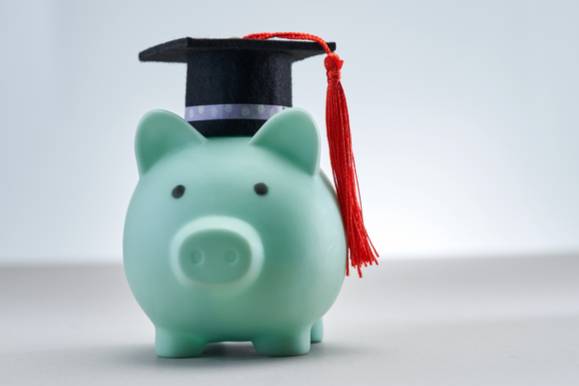 blue piggy bank wearing a small college cap and a red tassel 