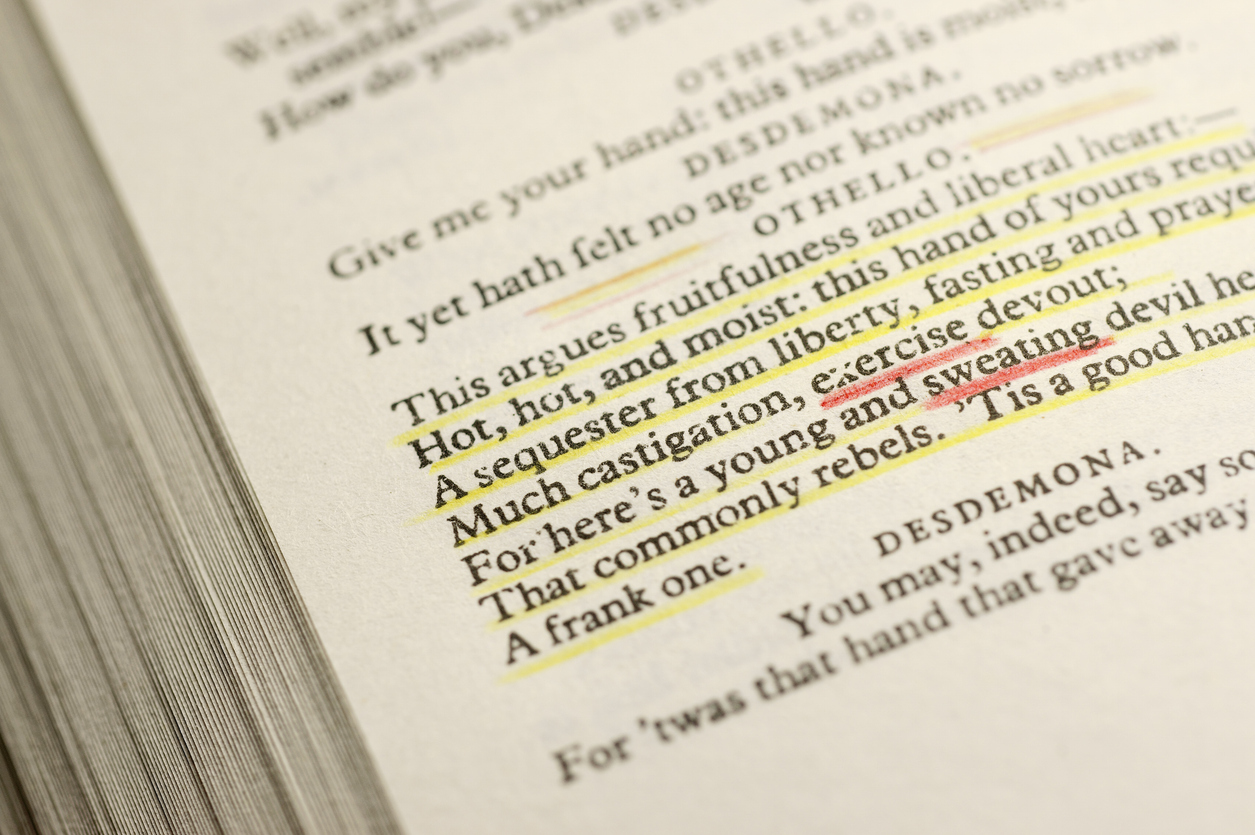 Close-up of a page containing the third act of William Shakespeare's "The Tragedy of Othello, the Moor of Venice". The words "sweating" and "exercise" are highlighted with coloured pencil. Focus on few words only. Paper texture visible where in focus. 