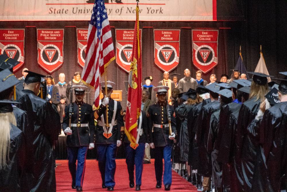 Flag guard walking down aisle for graduation